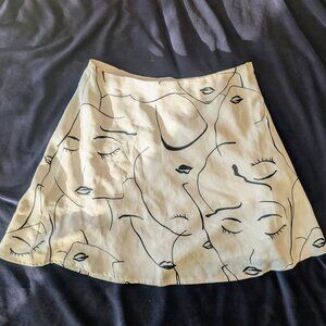 Mini skirt with cool B&W faces pattern.  by Princess Polly